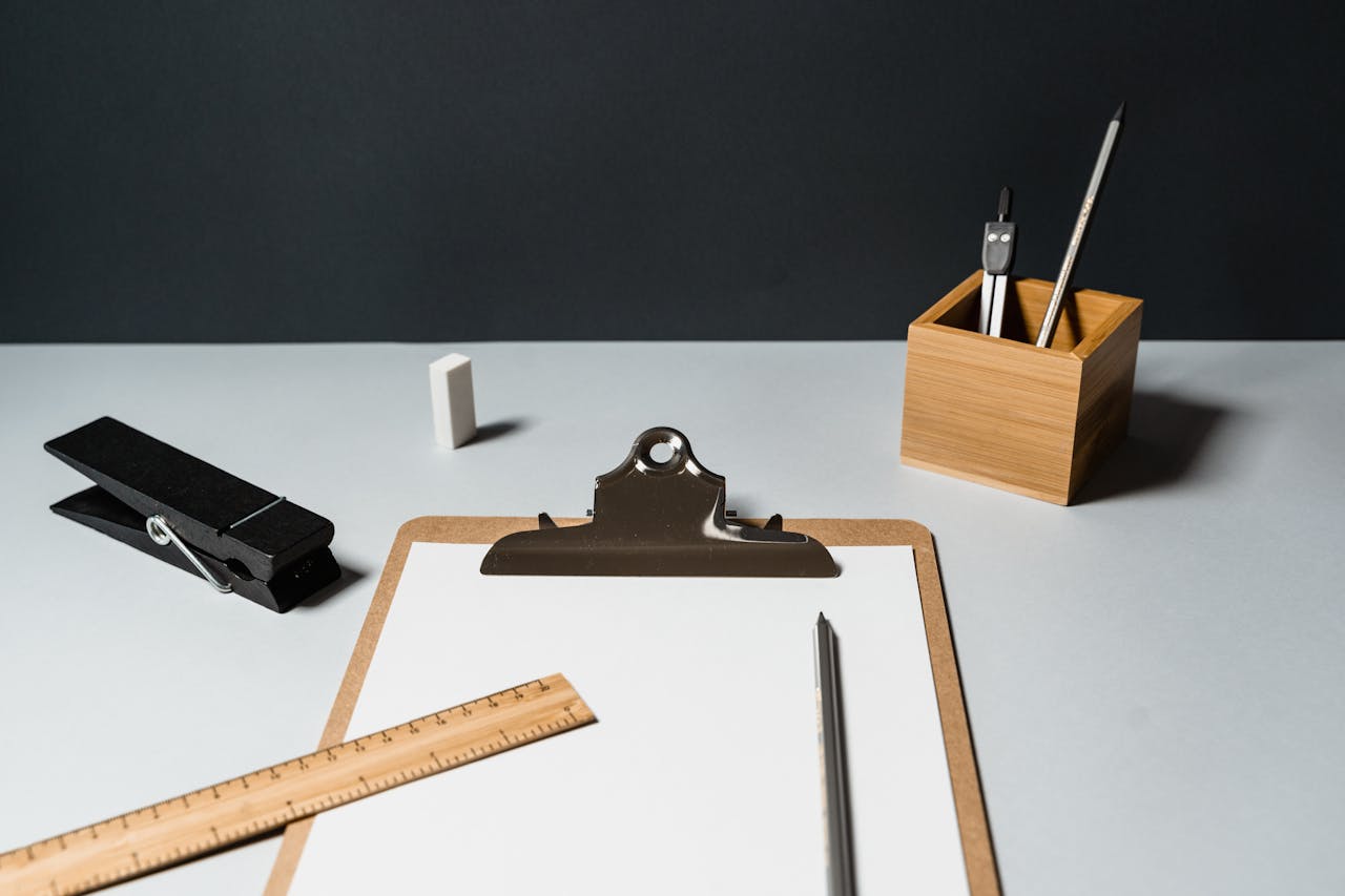 A minimalist office desk setup with essential office supplies on a dark background.